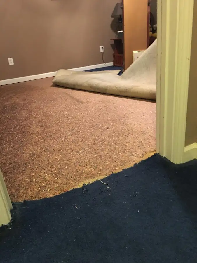 Carpet pad removal revealing water damage during Water Mitigation Services in Casa Grande